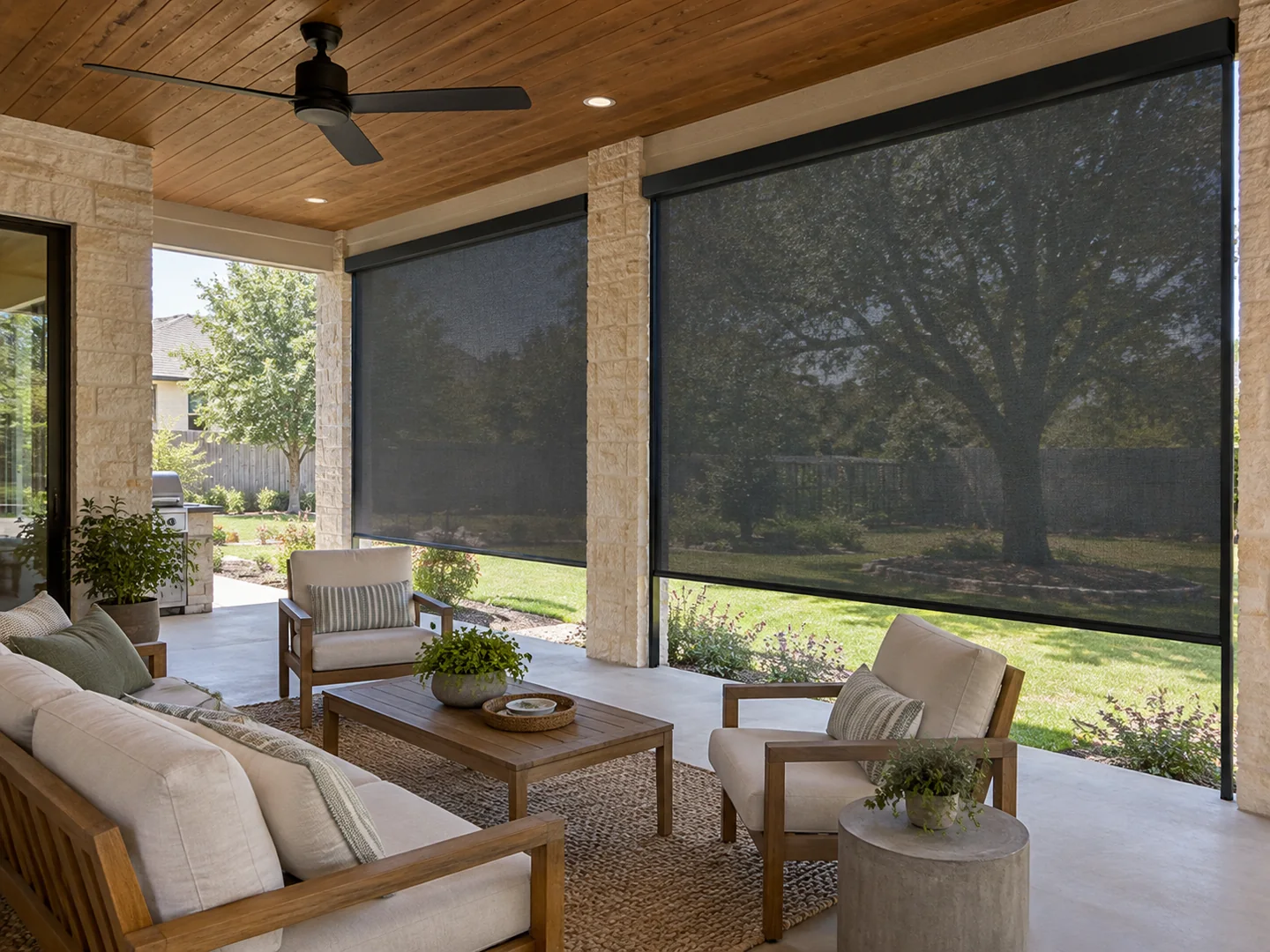 Covered patio seating area with charcoal exterior roller screens